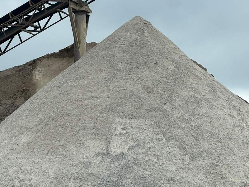 Stockpile of granite dust under a quarry conveyor