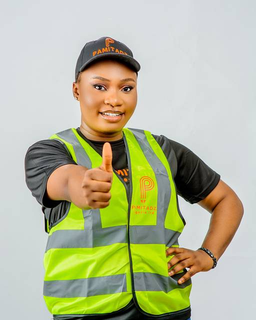 Pamitadz team member in a safety vest giving a thumbs up